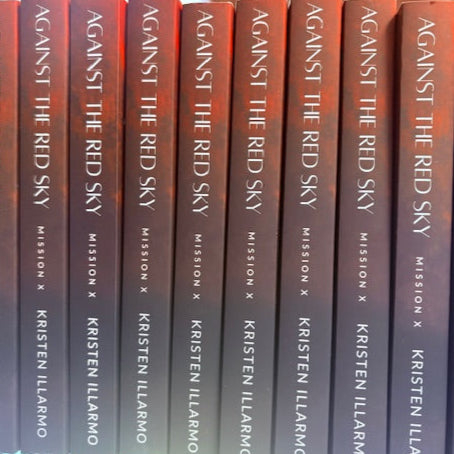 Stack of books titled 'Against the Red Sky' by Kristen Ilarmo