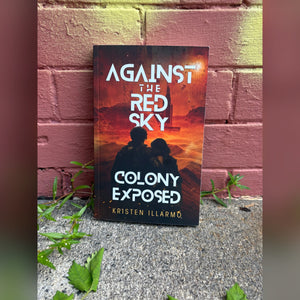 Colony Exposed paperback leaning against a brick wall