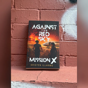 Mission X paperback leaning against a brick wall